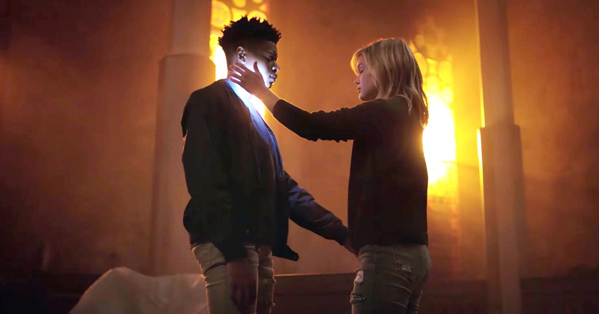 Dagger (Olivia Holt) holds her superpowered healing hand to Tyrone Johnson, aka Cloak (Aubrey Joseph)
