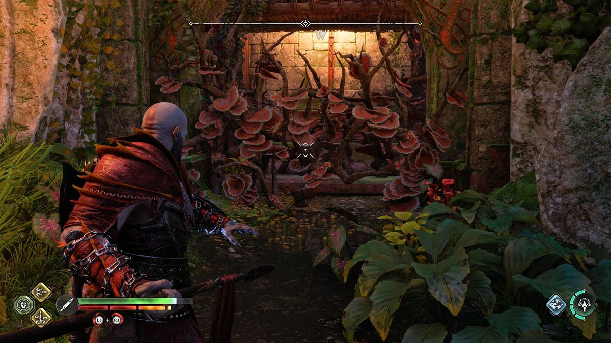 Kratos staart naar enkele brandbare wijnstokken in de regio Vanaheim van God of War Ragnarok.