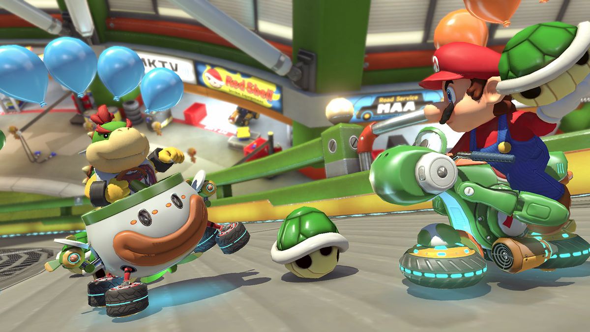 Mario apuntando un caparazón verde a Bowser Jr. en Mario Kart 8 Deluxe