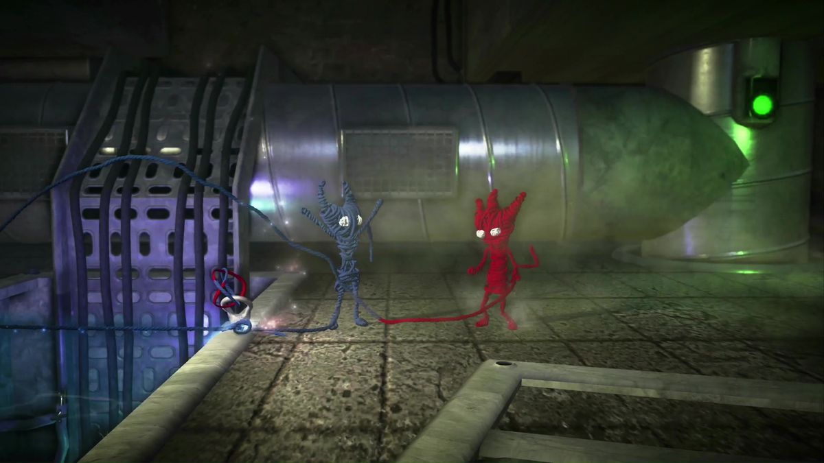 Un Yarny azul se encuentra a la izquierda con los brazos en alto. Un Yarny rojo está a la derecha, mirando a su compañero.