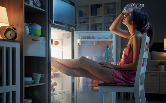 Woman Cooling Herself from Heat Wave Cold Bottle on Head