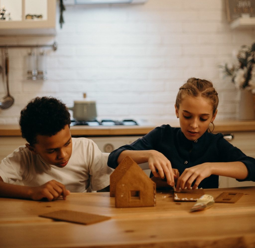 Boy and Girl Making a Gingerbread House