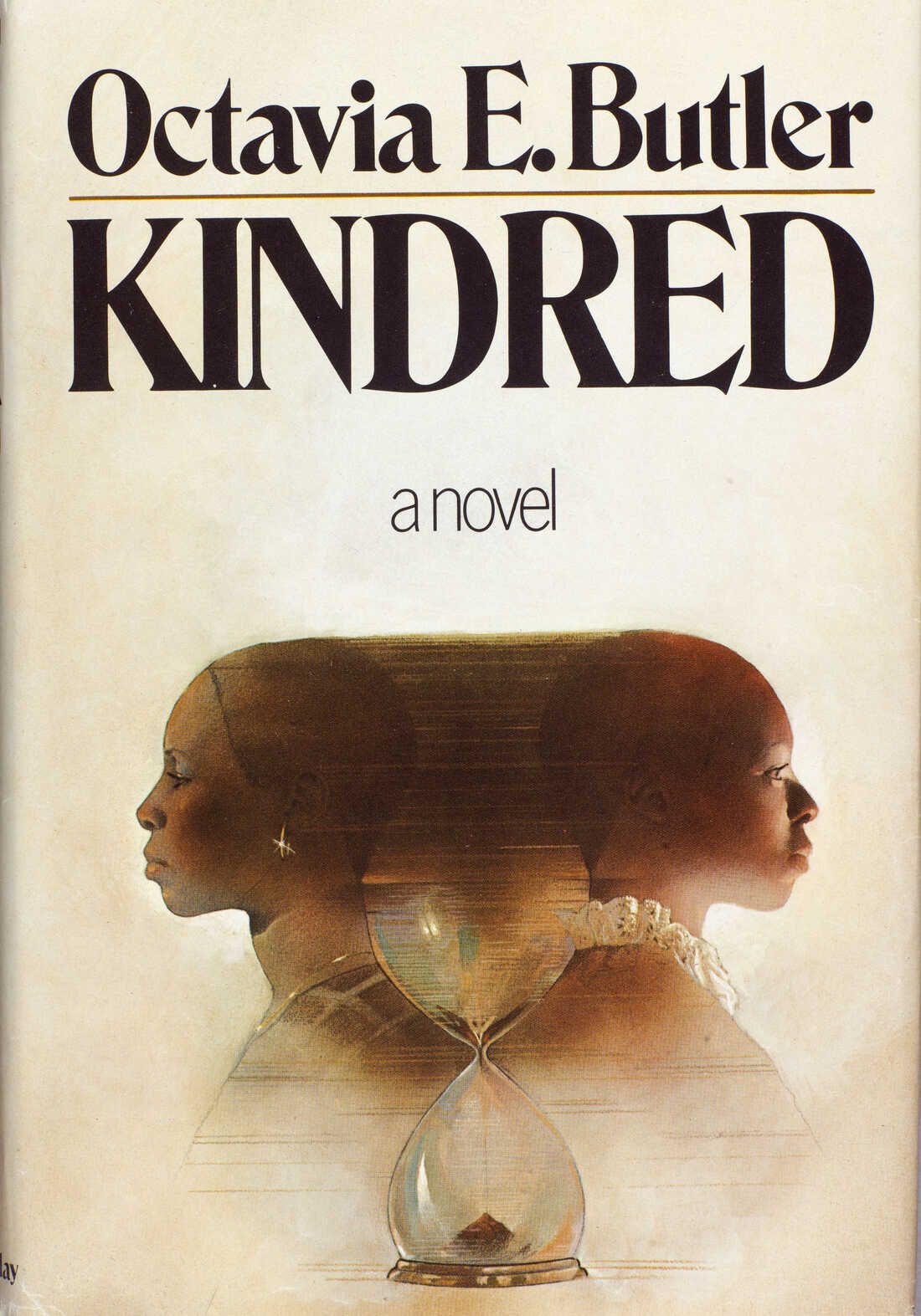 Two Black women stand with backs turned to each other fading into one another with an hourglass between them on the cover of Octavia Butler’s Kindred