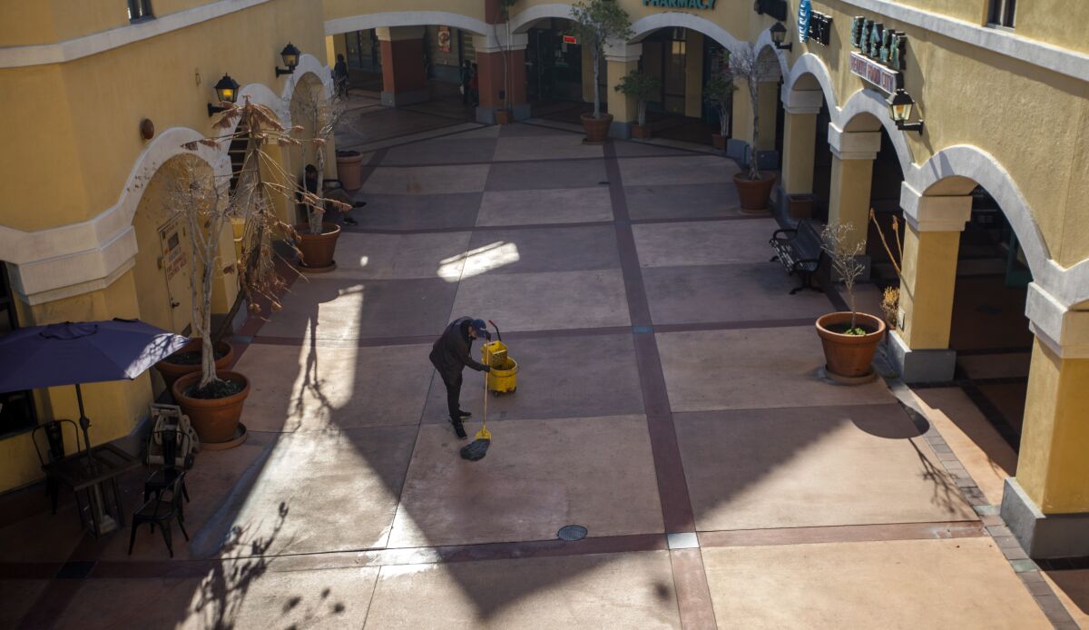 A person mops a tiled area