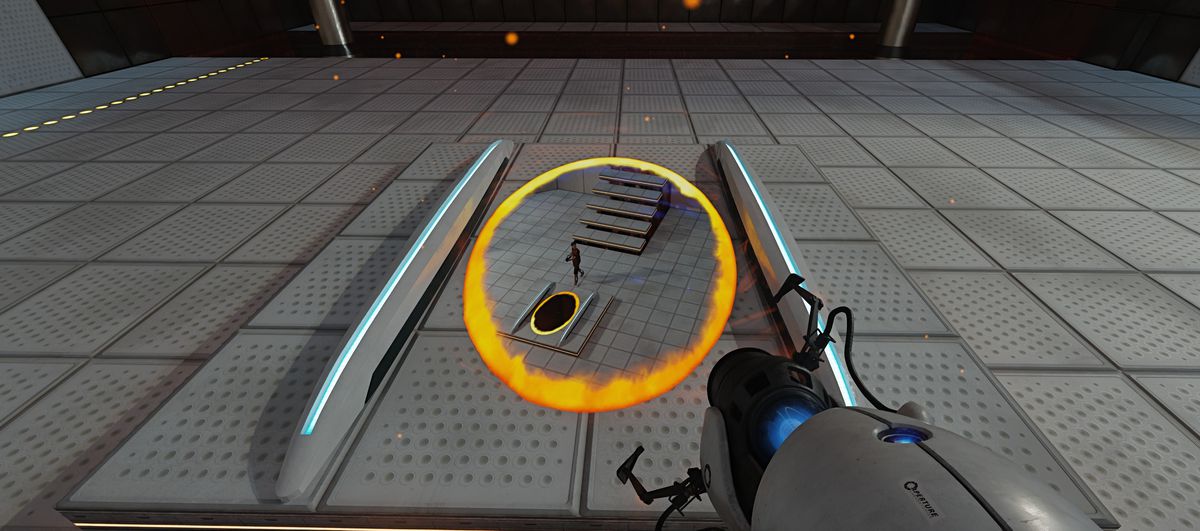 The player looks down at a portal in the floor in Portal. The portal shows a view of the player from above, indicating that the second portal is placed above them somewhere.