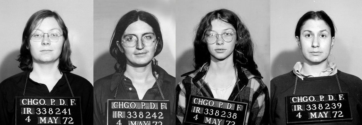 Three brunette women in glasses and a woman with her hair tied back stand in a police lineup as arrested members of the Janes