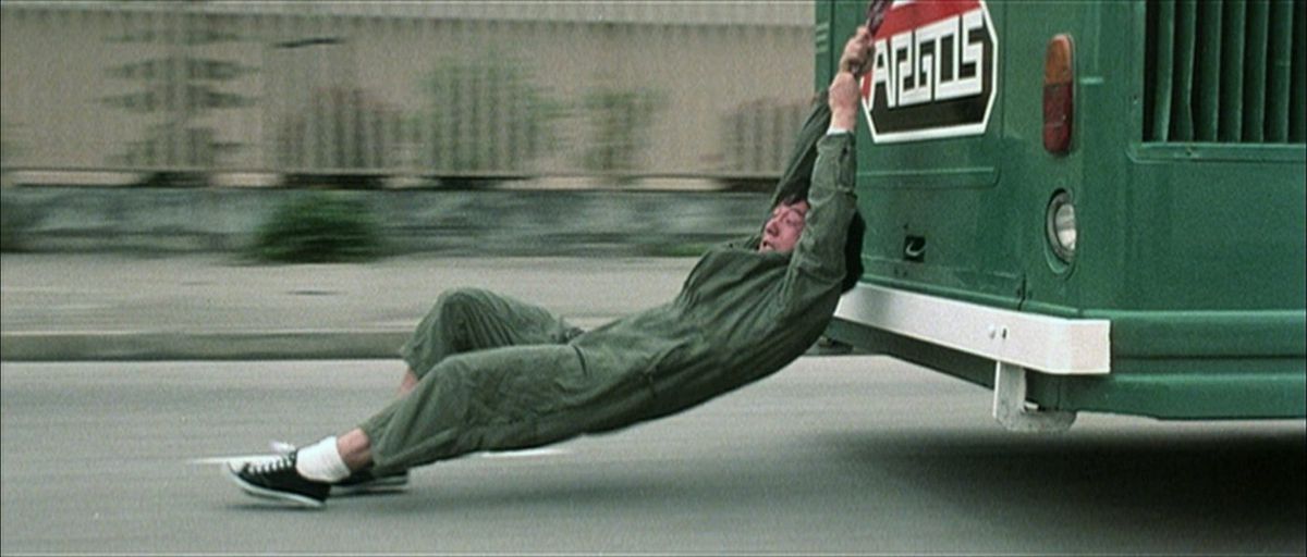 jackie chan holds on to a bus in police story