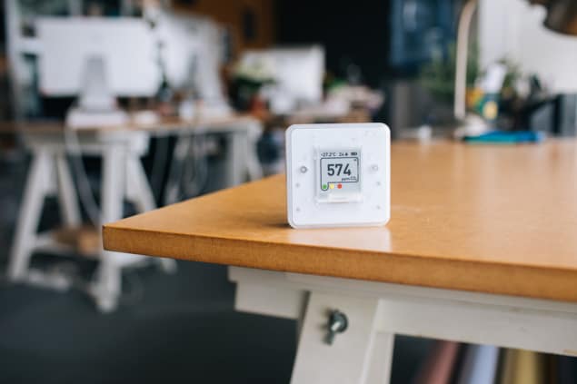 A CO2, humidity and temperature sensor sitting on a table. The CO2 reading is 574ppm, the humidity is 24% and the temperature is 27.2 degrees C