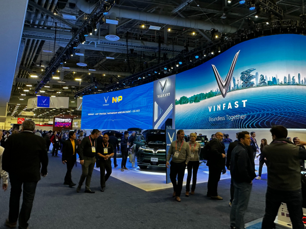 CES 2023 attendees reviewing EVs on display at the VinFast booth