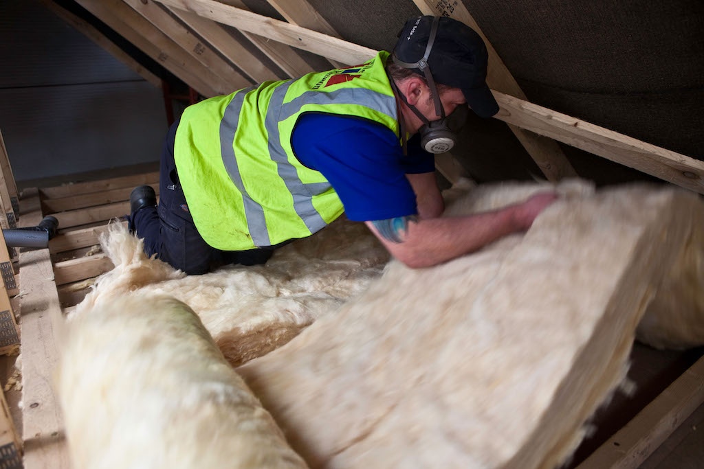 Sustainable loft insulation made from wool being installed in a roof in Kirklees, UK.