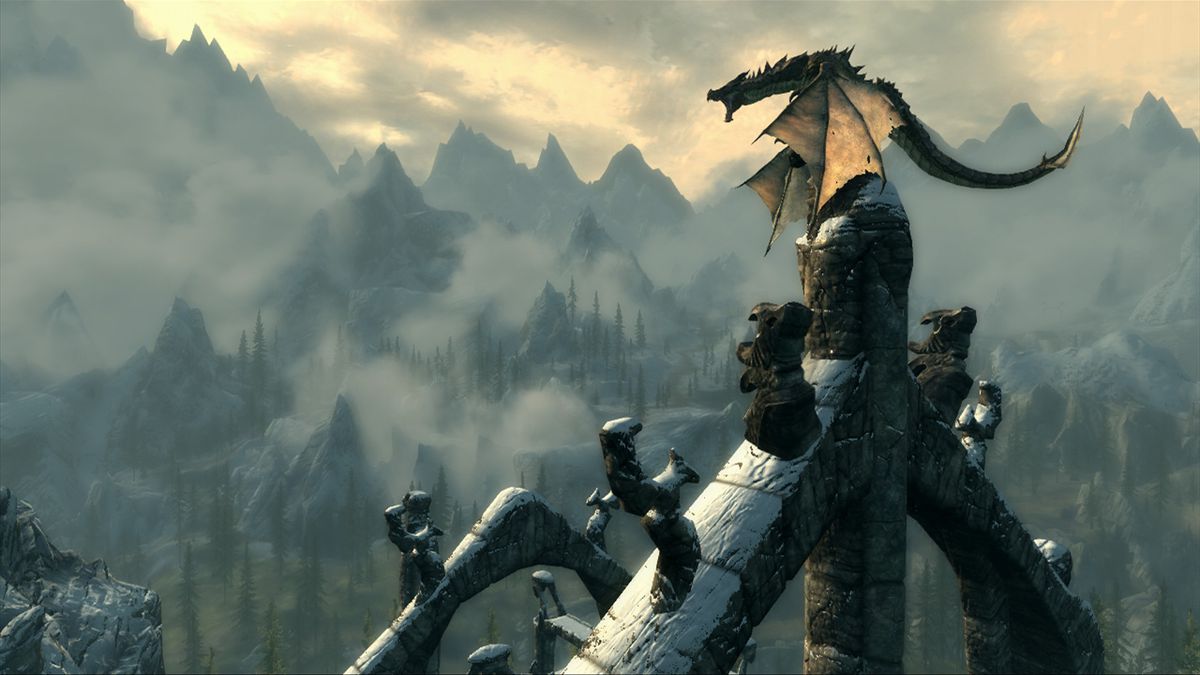 Skyrim - a dragon perched up on a castle spiral roars menacingly. In the distance are mountains and sky.