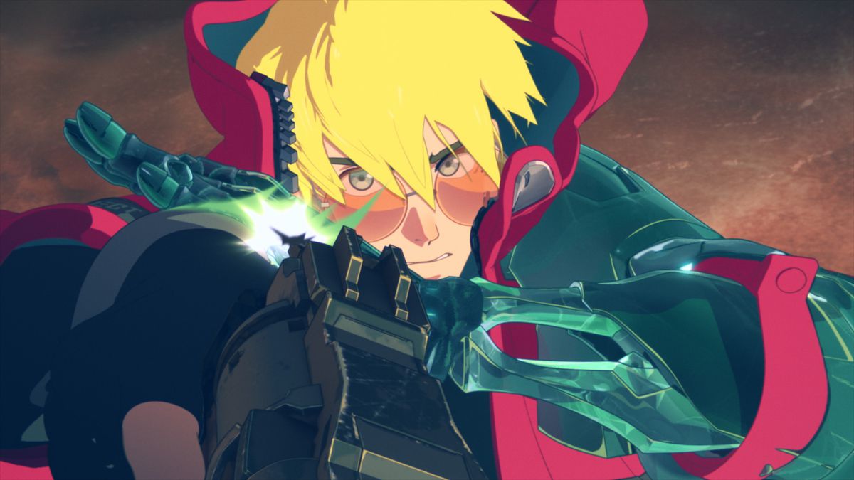 An image of Vash the Stampede looking directly into the camera as he points his gun towards up. His hair is being blown by wind and covers his eyes partially.