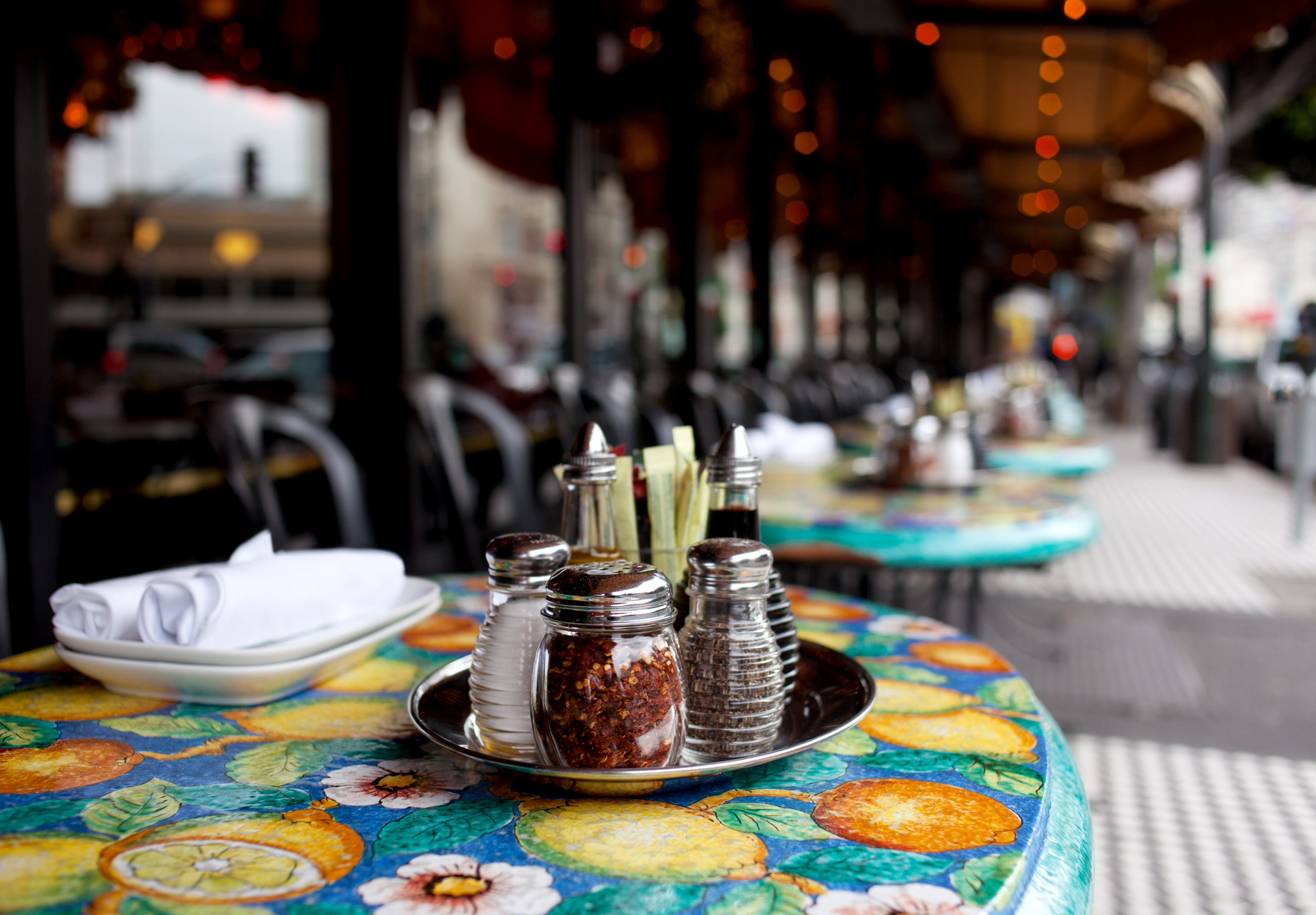 A colorful table on a sidewalk in a restaurant 