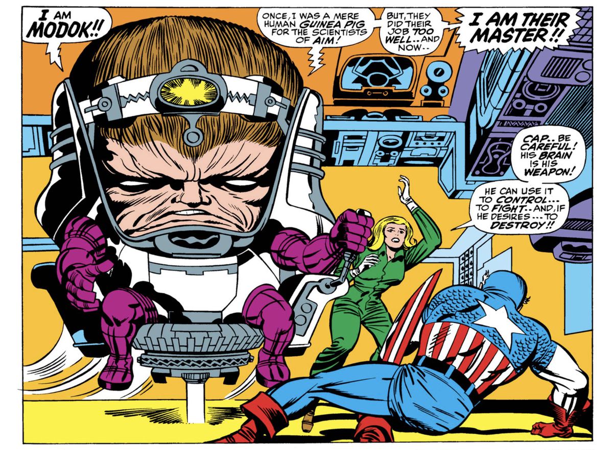 “I am MODOK!!” declares MODOK before a prone Captain America, “Once, I was a mere guinea pig for the scientists of AIM! But, they did their job too well... and now... I AM THEIR MASTER!!” MODOK is a huge head, floating assisted in a hover chair, his nearly vestigial arms and legs dangling, in Tales of Suspense #94 (1967).