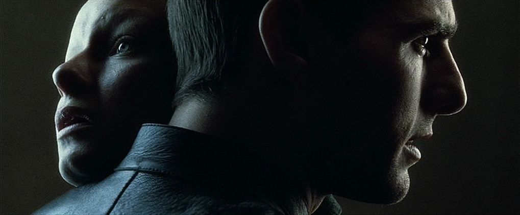 Tom Cruise’s John Anderton holds up the female precog as they embrace and look in different directions in profile in Minority Report