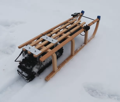 A wooden sled with an electric drive system installed