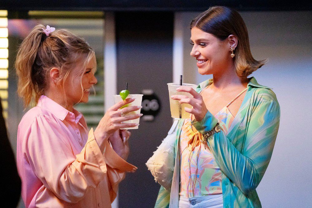 Ariana Madix and Raquel Leviss stand facing each other with their glasses raised during a still from Vanderpump Rules.