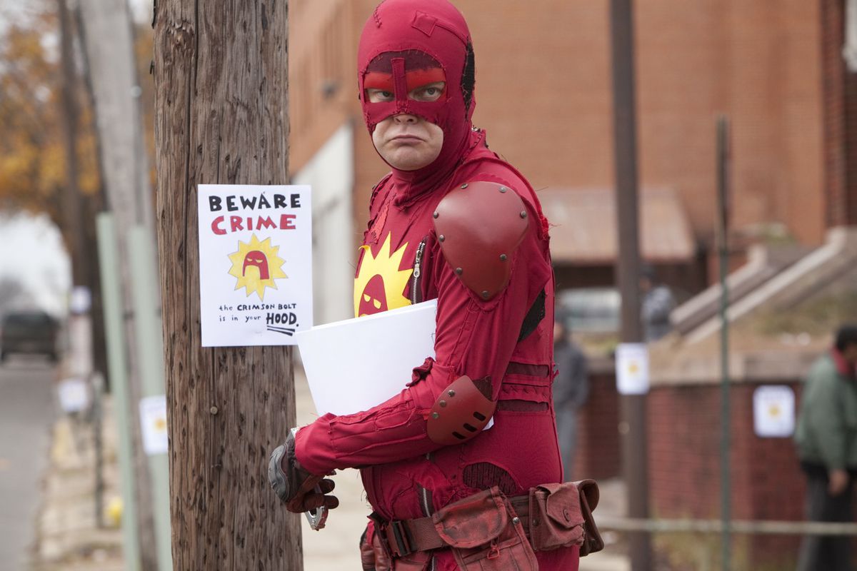 The Crimson Avenger (Rainn Wilson) scowls as he posts hand drawn “BEWARE CRIME” flyers around his neighborhood in Super. 