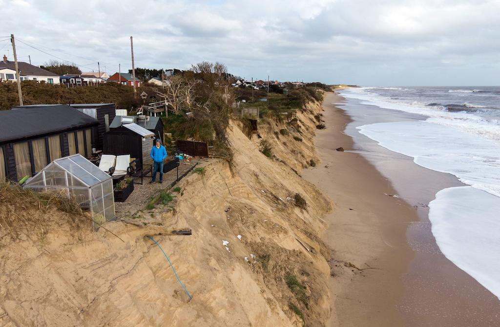Former soldier Lance Martin, 63, stands in the back garden of his home in Hemsby, Norfolk, where his back door is now no more than six metres (20ft) from the cliff edge after the Beast from the East battered the coast in March 2018.