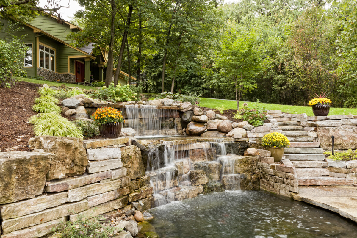 Beautifully landscaped waterfall and koi pond _ getty