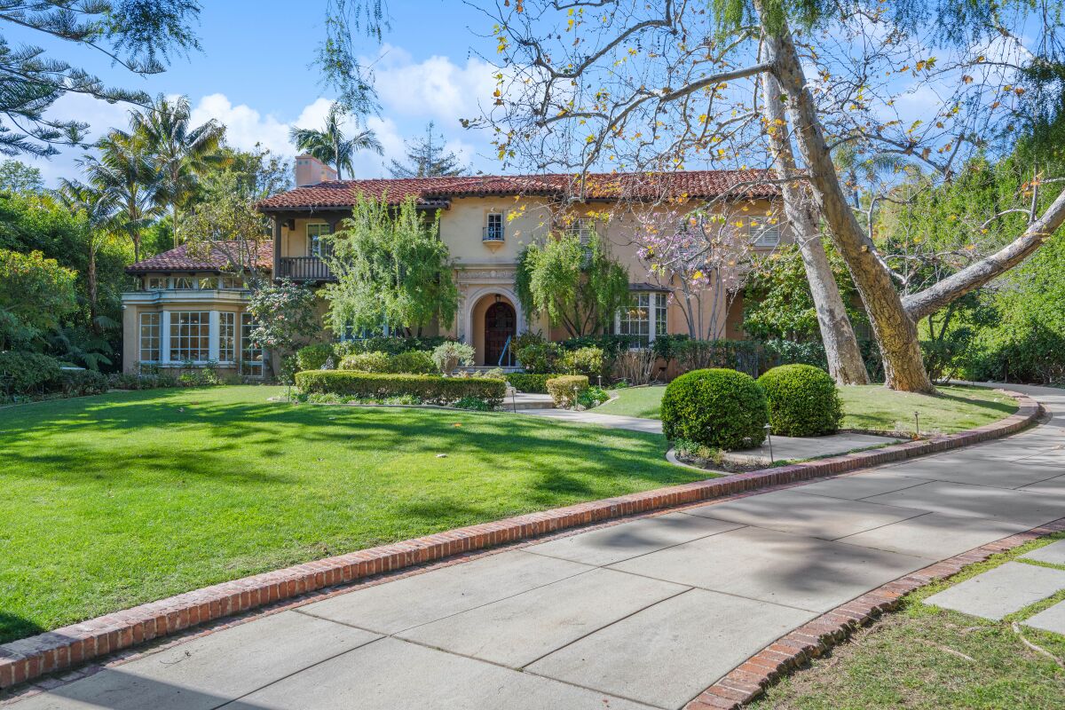 A long driveway winds toward a Spanish-style mansion in Brentwood