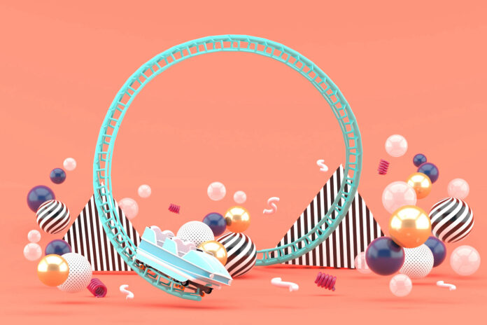 Pembe Bir Arka Plan Üzerinde Renkli Toplar Arasında Mavi Bir Roller Coaster