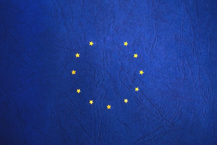 A blue backdrop with yellows arranged in a circle, just like the EU flag