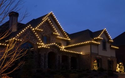 Exterior of home with a few strands of Christmas lights.
