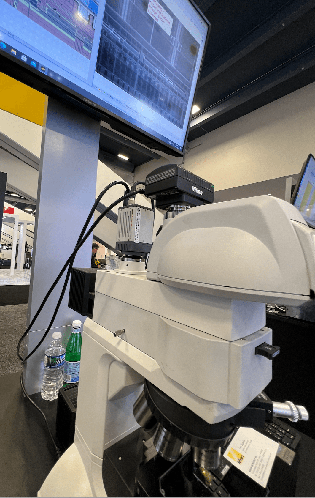 Nikon camera attached to an infrared camera on a microscope makes it possible to see through silicon layers, at the Nikon booth, Semicon West 2023. Source: Semiconductor Engineering/ Susan Rambo