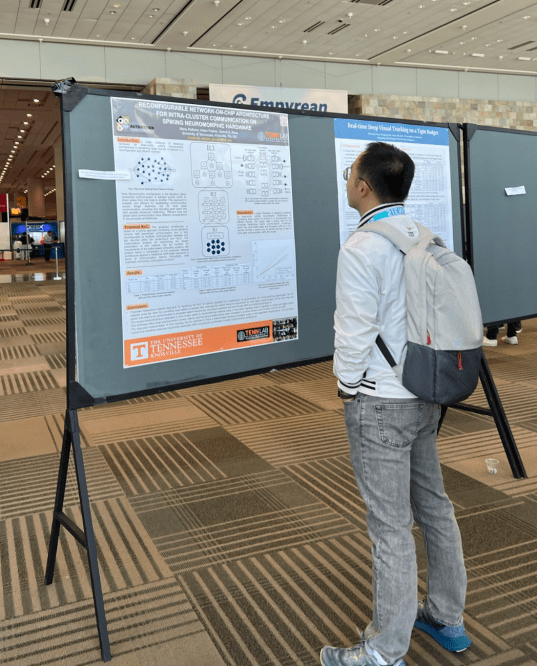 Man looking at research posters at DAC 2023 in San Francisco, July 11. Source: Semiconductor Engineering / Susan Rambo