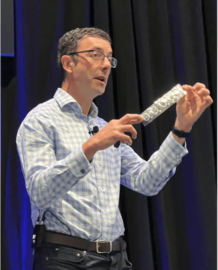 Richard Price, CTO of Pragmatic Semiconductor, holds up a strip of flexible electronics. Source: Semiconductor Engineering / Susan Rambo