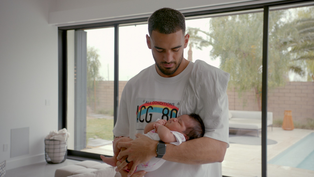 Marcus Mariota holding his child in his arms in Netlfix’s Quarterback