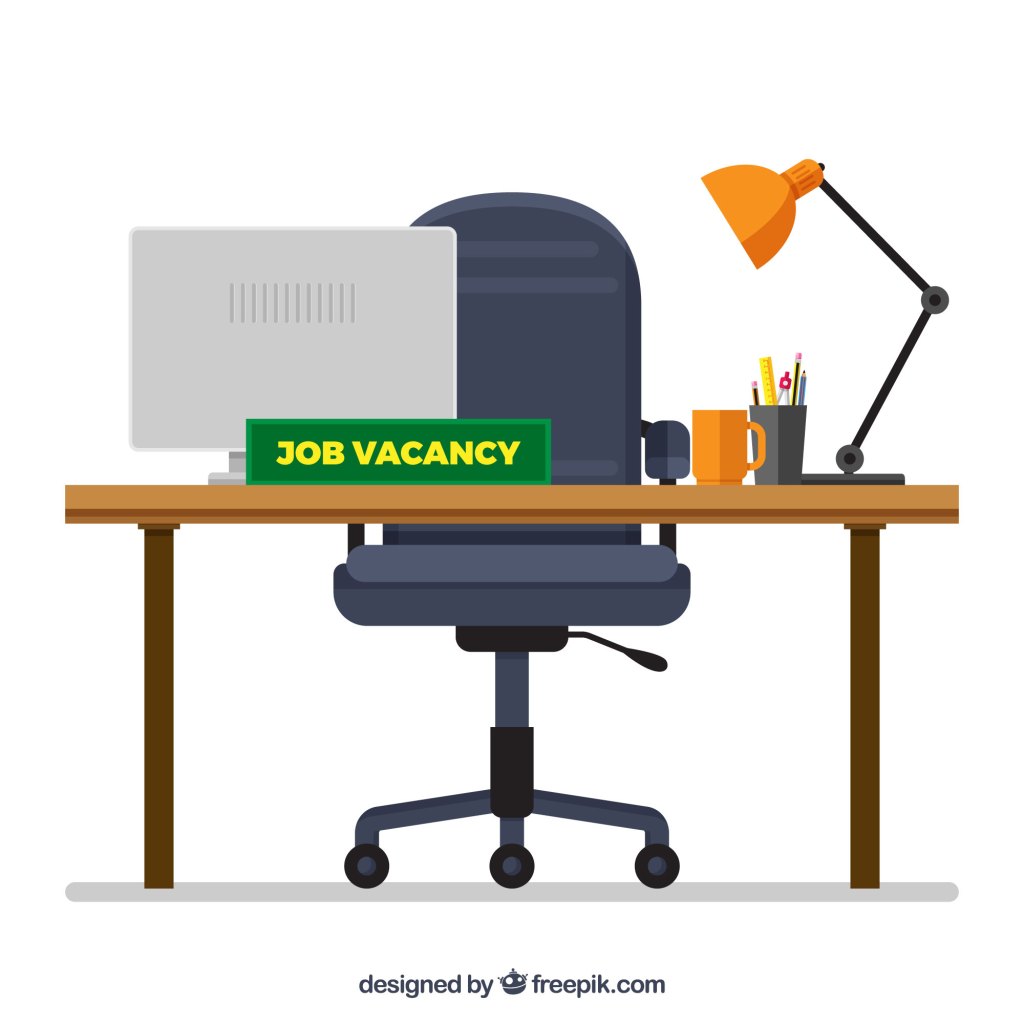 "Job Vacancy" 게시판이 있는 업무용 책상의 이미지.