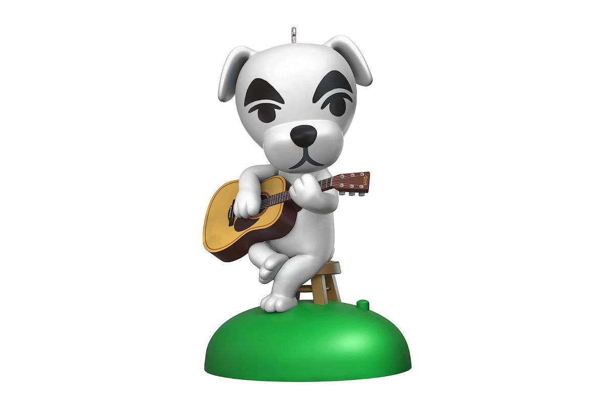 A holiday ornament from Hallmark of K.K. Slider, a character from Nintendo’s Animal Crossing video game, sitting on a stool while playing an acoustic guitar.