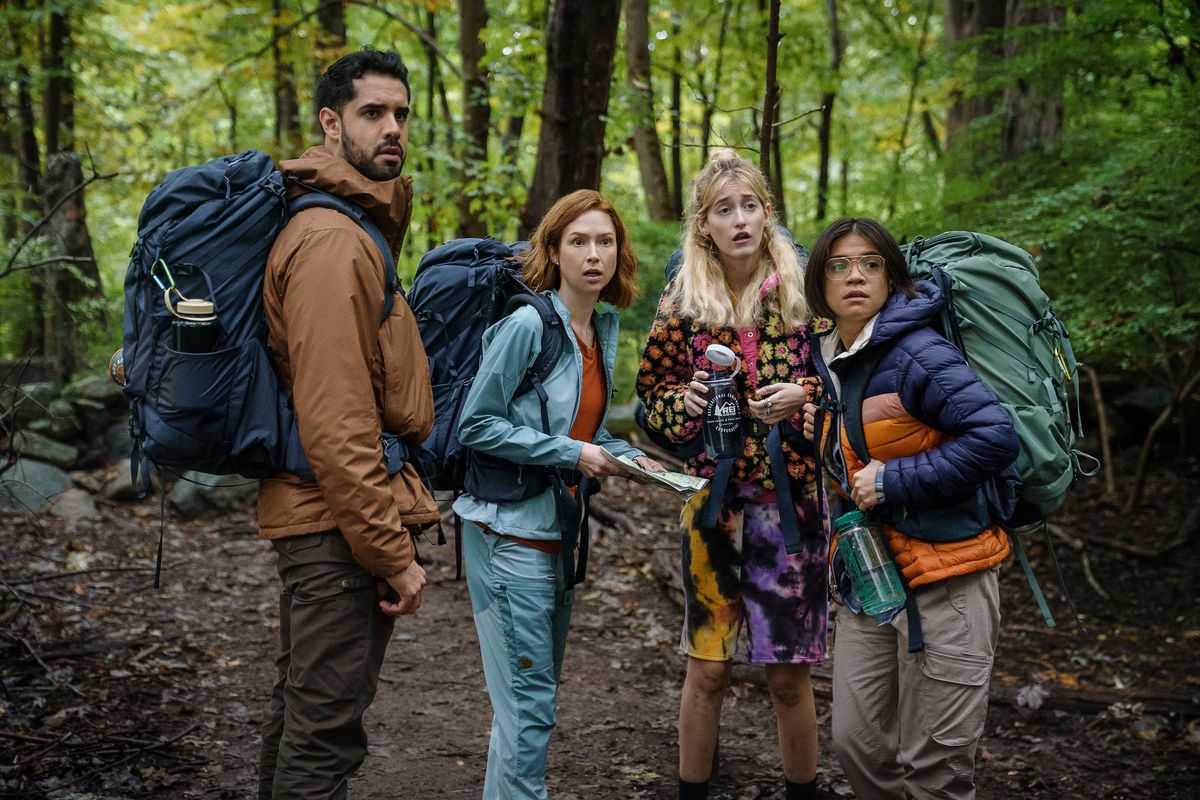 (L to R) Esteban Benito as Mason, Ellie Kemper as Helen, Gus Birney as Kaylee and Julia Shiplett as Sue go hiking with backpacks in Happiness for Beginners.