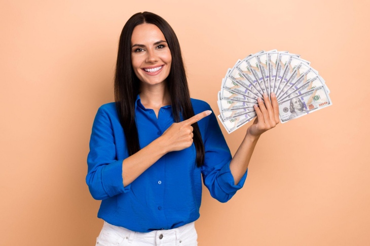 woman holding a fan of money