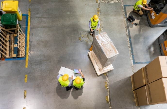 Employees analyzing how to boost warehouse performance