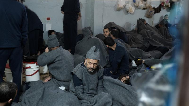 Prisoners suspected of being part of the Islamic State, lie inside a prison cell in Hasaka, Syria, January 7, 2020, photo by Goran Tomasevic/Reuters