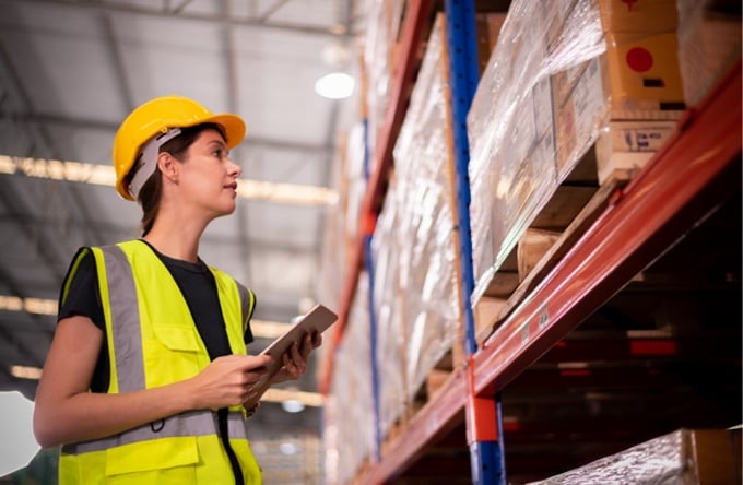 Warehouse employee streamlining inventory to reduce warehouse costs.