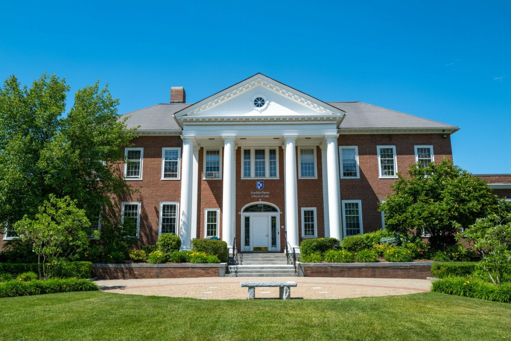 Bâtiment de la Franklin Pierce School of Law de l'Université du New Hampshire (UNH) avec le logo bleu et blanc « UNH » au centre.