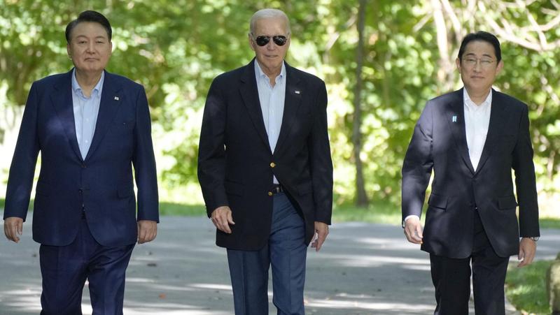 (l-r) South Korean President Yoon Suk-yeol, U.S. President Joe Biden, and Japanese Prime Minister Fumio Kishida walk to a joint press conference after their summit talks at the U.S. presidential retreat at Camp David near Washington, D.C., August 18, 2023, photo by Kyodo via Reuters Connect