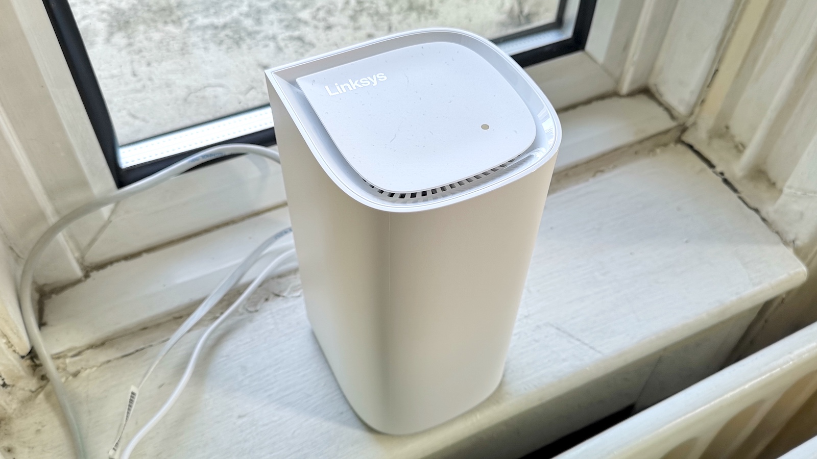 A Linksys Velop Pro 6E mesh Wi-Fi unit connected to a modem