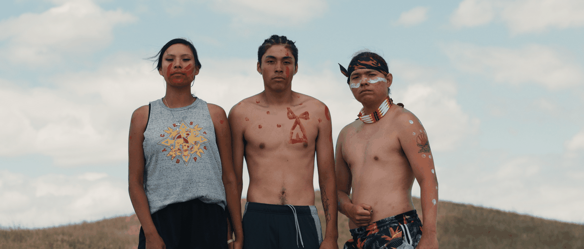 Drie demonstranten dragen gezichts- en lichaamsverf in Lakota Nation versus de Verenigde Staten.