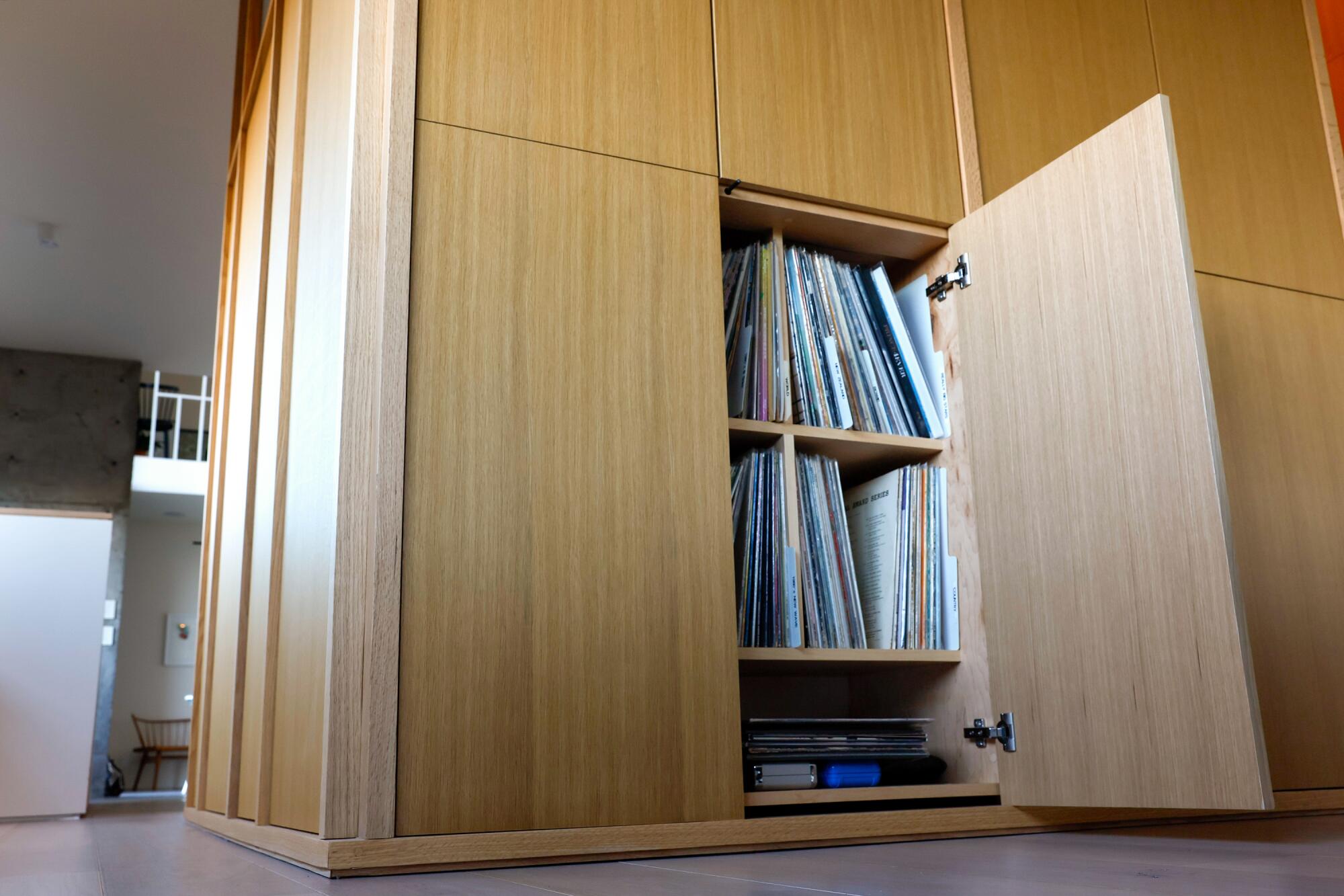 Los discos están escondidos detrás de gabinetes de madera clara que parecen escondidos en las paredes.