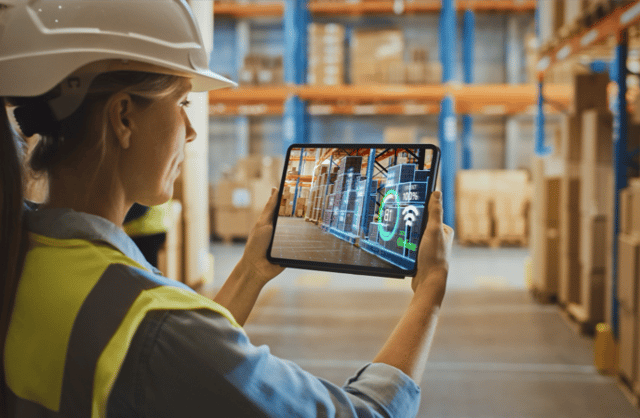 Warehouse manager using a tablet to manage workflows in an automated warehouse.
