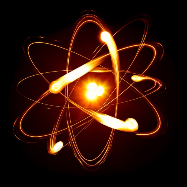 Dessin d'artiste d'un noyau avec des électrons en orbite autour de lui, tous orange brillant