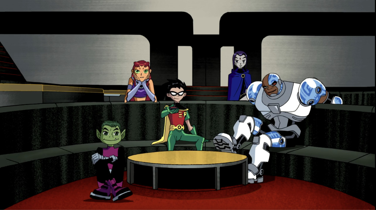 Beast وStarfire وRobin وRaven وCyborg يجلسون على الأريكة في مقرهم ويشاهدون التلفزيون