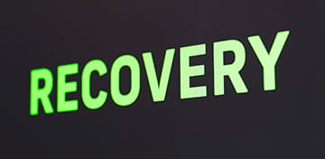 An Image With a Big Green Text, Showing the Word "Recovery" 