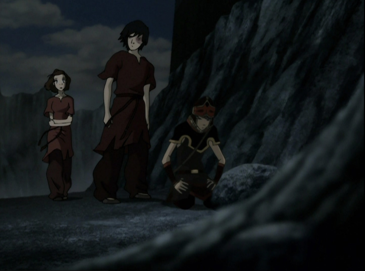 Suki and Zuko standing behind Sokka, who’s on the ground with his head bowed