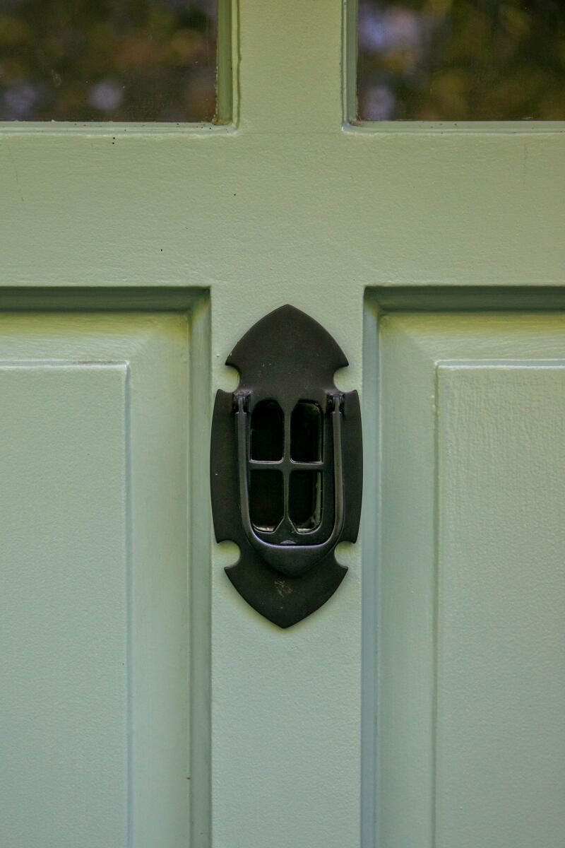 A closeup of the door knocker on the front door of the Ivanhoe Vista house.